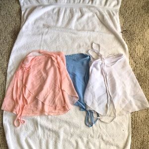 Three ballet skirts (blue, pink, and white)